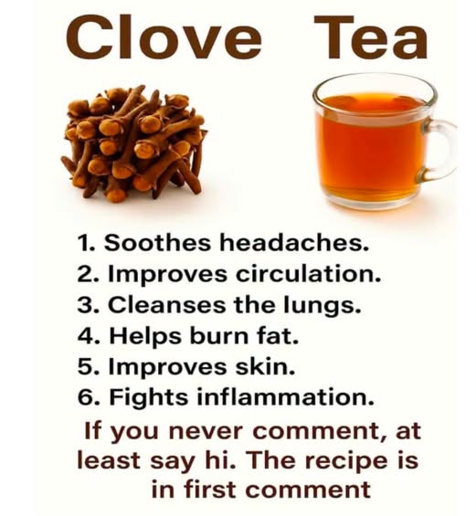 Glass mug of clove tea beside a small pile of whole dried cloves.