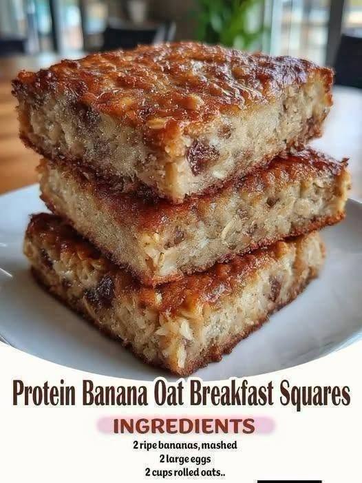 Banana oat breakfast squares stacked on a plate with visible rolled oats. Use this alt text only if it accurately describes your uploaded photo.