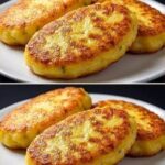 Three thick oval potato patties with golden-brown surfaces and green herb flecks on a white plate.