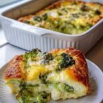 Golden broccoli and cauliflower cottage cheese bake with a thick square serving on a white plate.